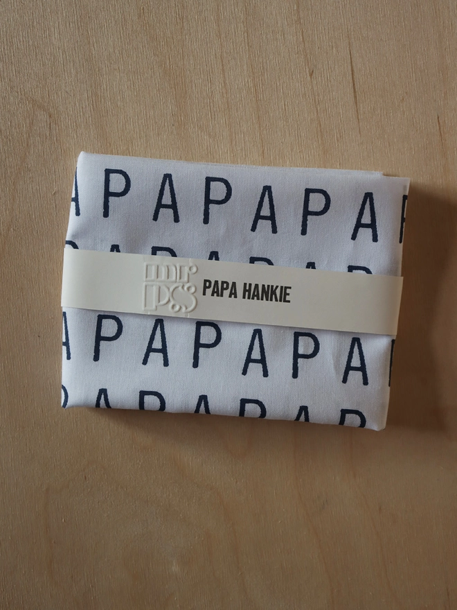 A Mr.PS PAPA hankie folded to show the paper wrap band