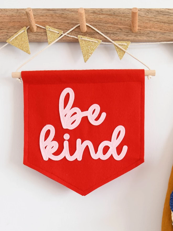 red and pink be kind wall banner.