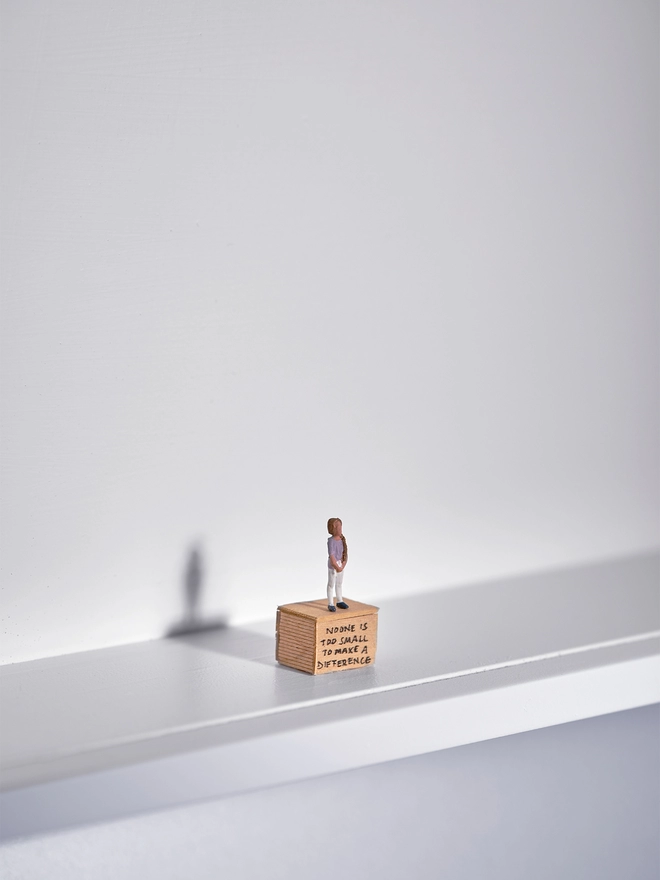 Miniature scene in an artbox showing a tiny Greta Thunberg figurine standing on a soapbox