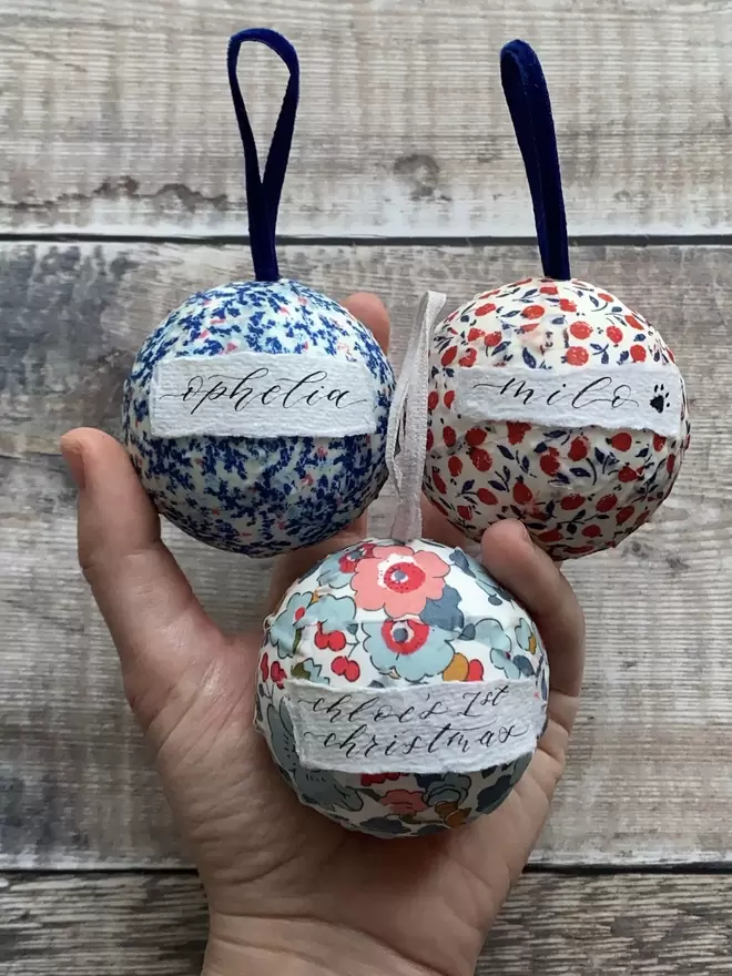 Three Personalised mini Liberty baubles held in hand