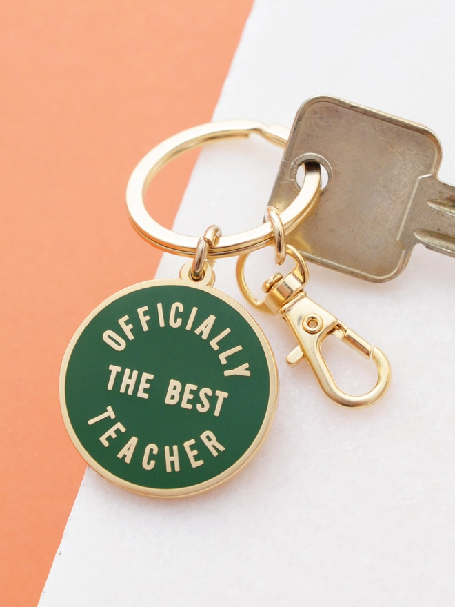 green keyring with 'officially the best teacher' design