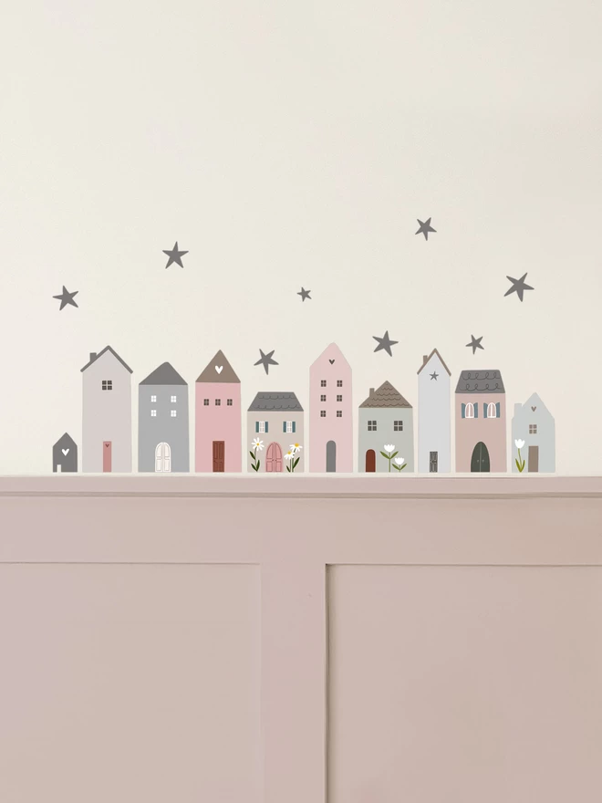 Dusty pink wall panelling with off white walls and little village house wall stickers