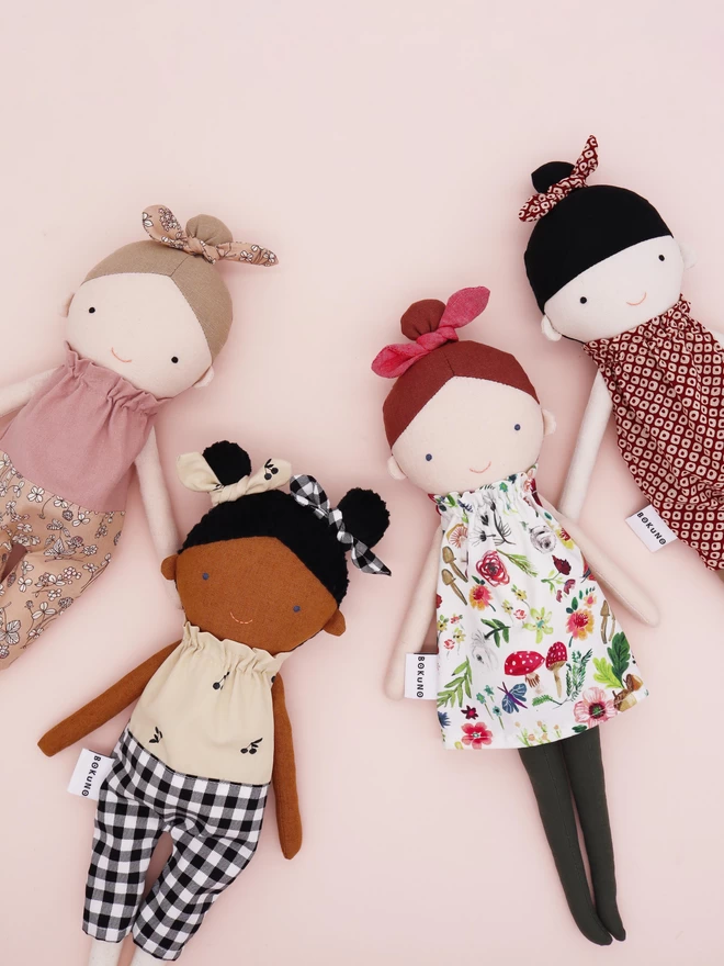 four fabric dolls in different ethnicity