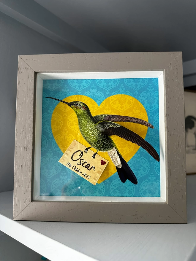 Personalised new baby hummingbird in frame, yellow heart and blue background