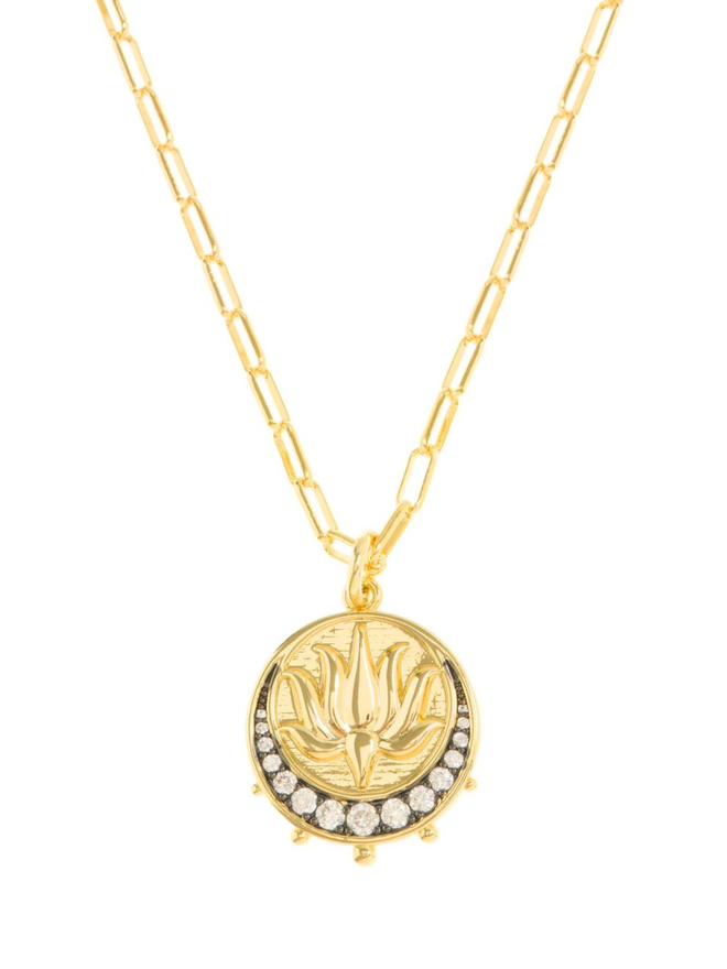 Gold lotus moon charm with white crystals hanging from a gold paperclip chain necklace on a white background