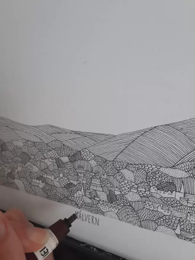 Print of a detailed black and white pen and ink drawing of Great Malvern and Malvern hills, in a soft white mount