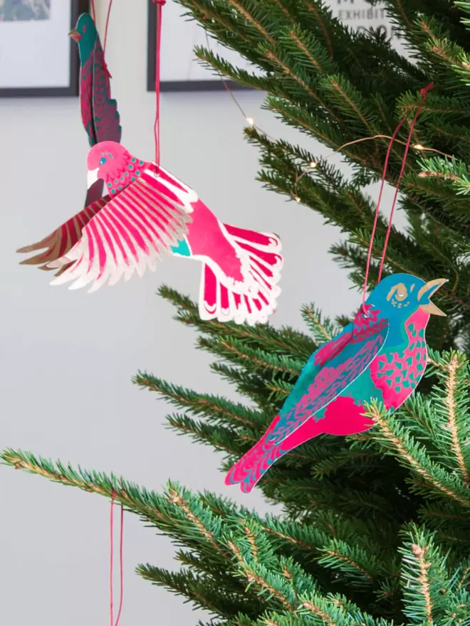 Paper birds hanging on Christmas tree