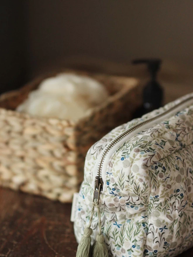 Wash Bag in Riverbank print together with a basket of bath essentials