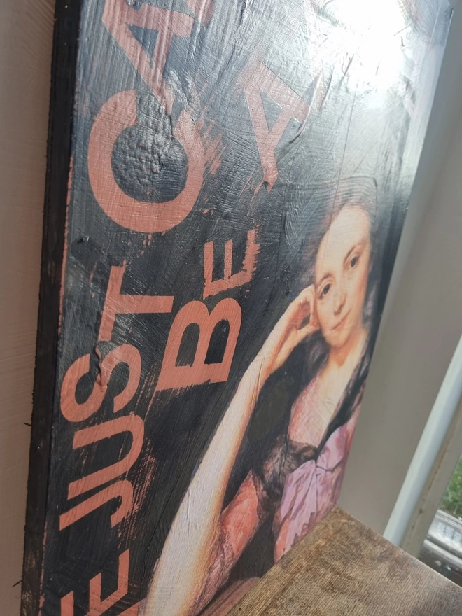 Painted ply wood art panel for the wall featuring an antique regal portrait of a lady. The colours are Peachy pink and black and the text reads in pink ‘she just can’t be arsed’.