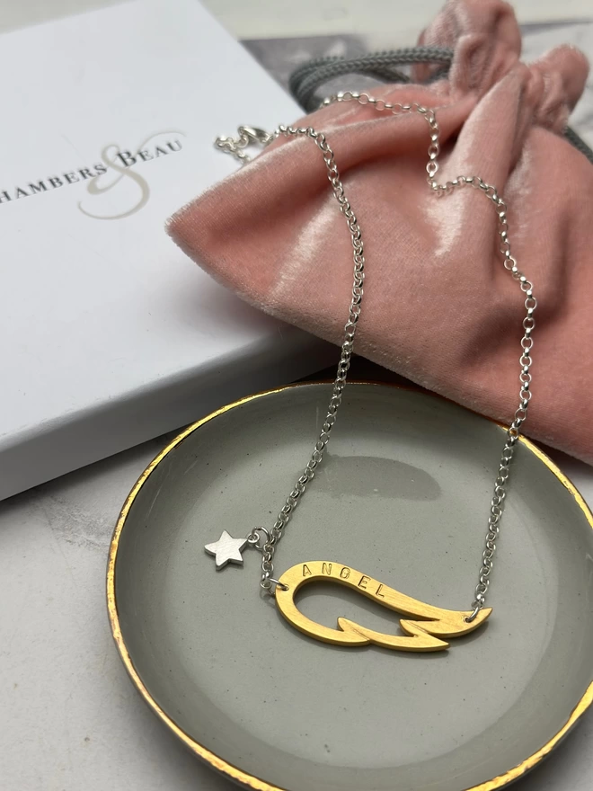 sterling silver chain with gold plated wing charm and small silver star