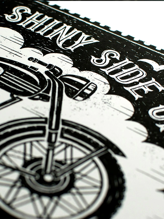 detail of black and white motorbike print with hand lettering