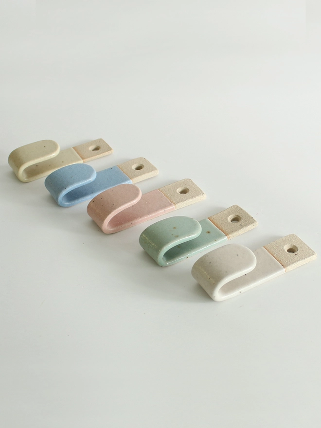 Side view of all 5 pastel wall hooks