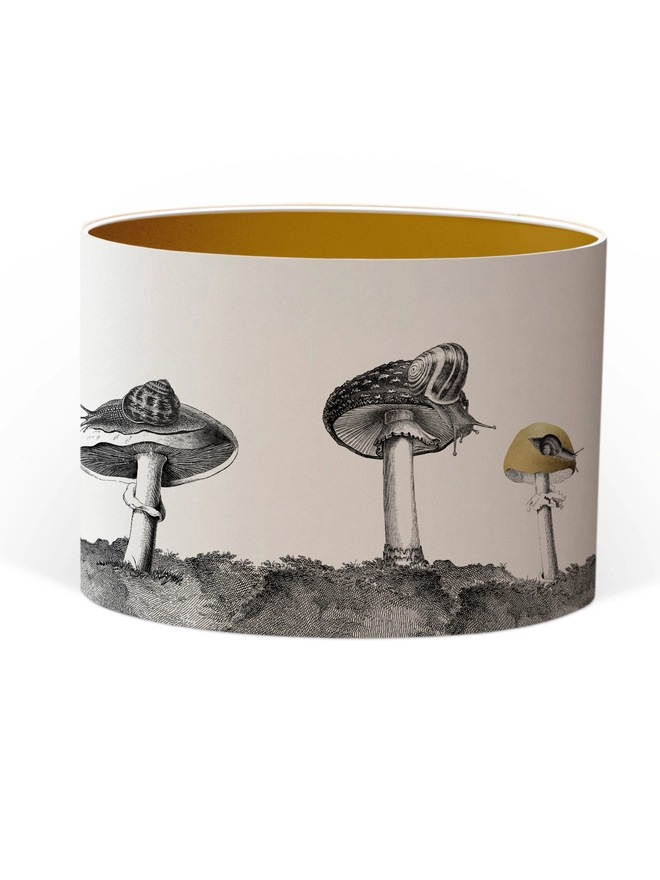 Drum Lampshade featuring snails sitting on mushrooms and toadstools with a Gold inner on a white background