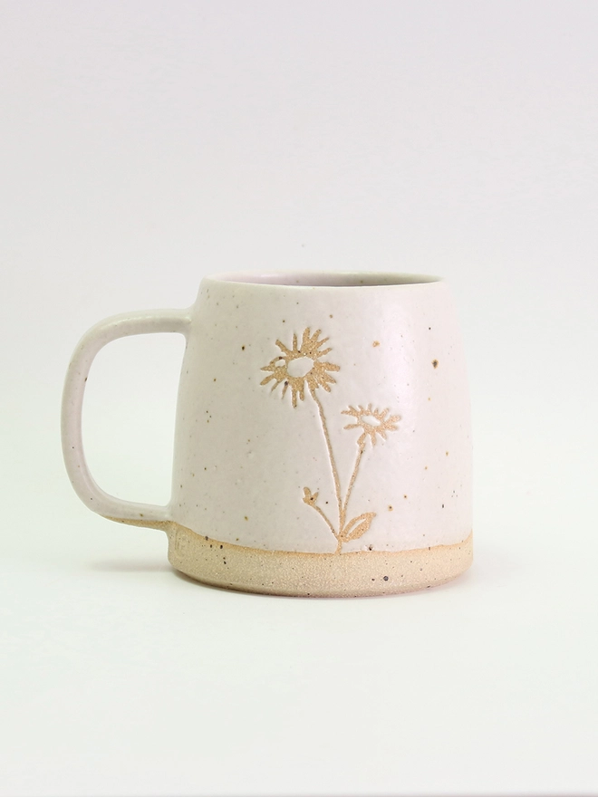 White stoneware mug with flecked clay and Aster flower illustration