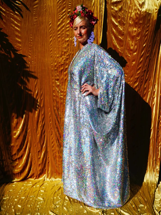 Silver Holographic Sequin V-neck Kaftan Gown seen from the side.