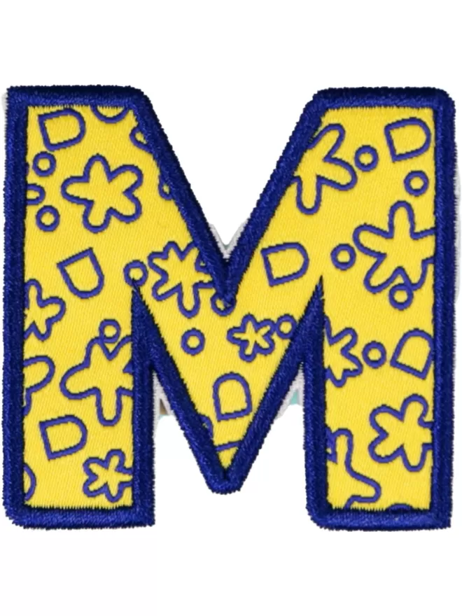 An 'M' patch with a blue and yellow pattern.