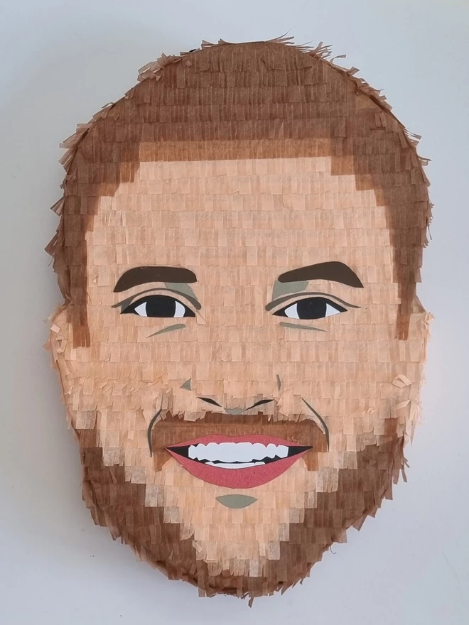 custom made portrait pinata of a smiling man with a beard