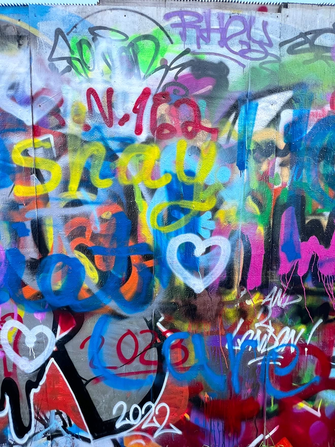 Photograph of colourful graffiti wall taken by Evi Antonio showing brightly coloured spray paint