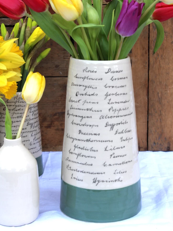 large handmade ceramic vase decorated with handwritten flowers