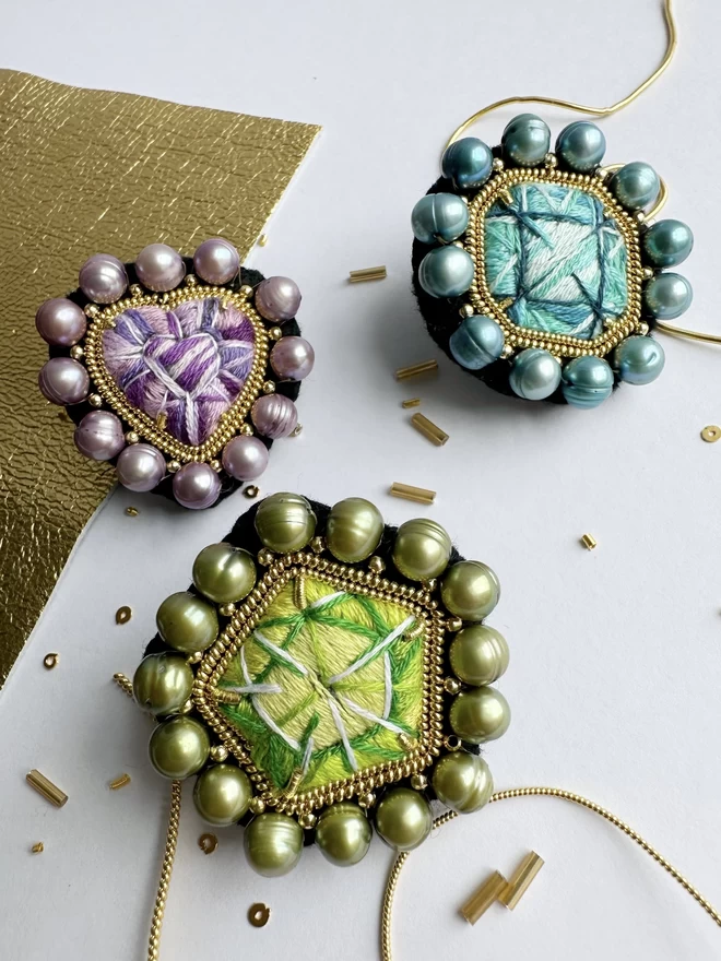 Set of three gemstone brooches