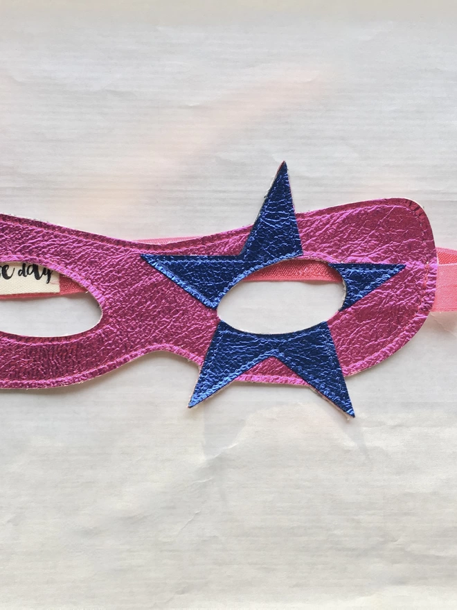 close up of pink & blue metallic leather Star detail on superhero mask