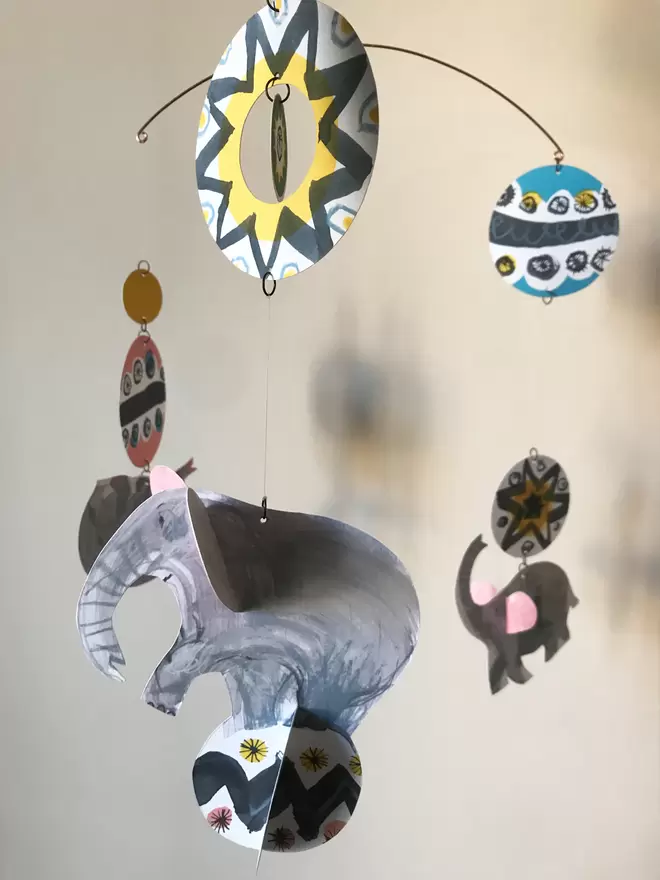 Esther Kent designed Circus Elephants mobile. Grey hand-drawn cut out elephants combined with mid-century circus patterns.