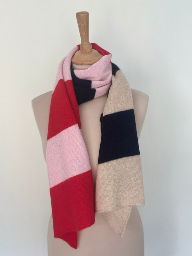 Red pink navy stripe scarf shown on a mannequin