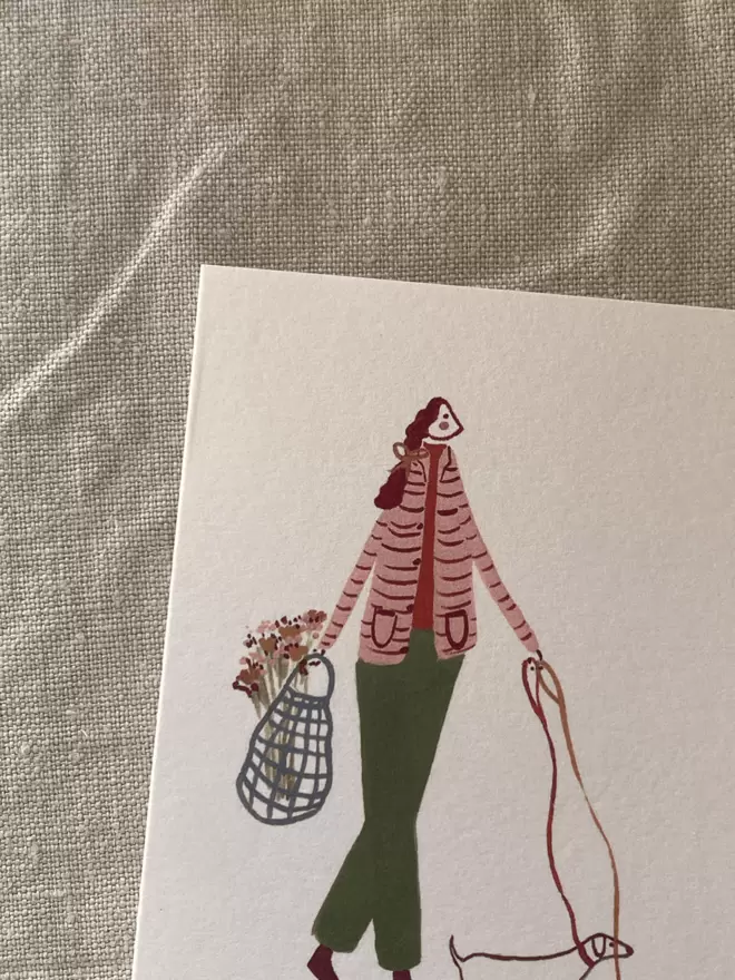 greetings card with a lady walking her dog on it. 