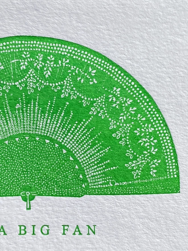 Close up of a white card with a green illustration of a fan with text reading 'A Big Fan'