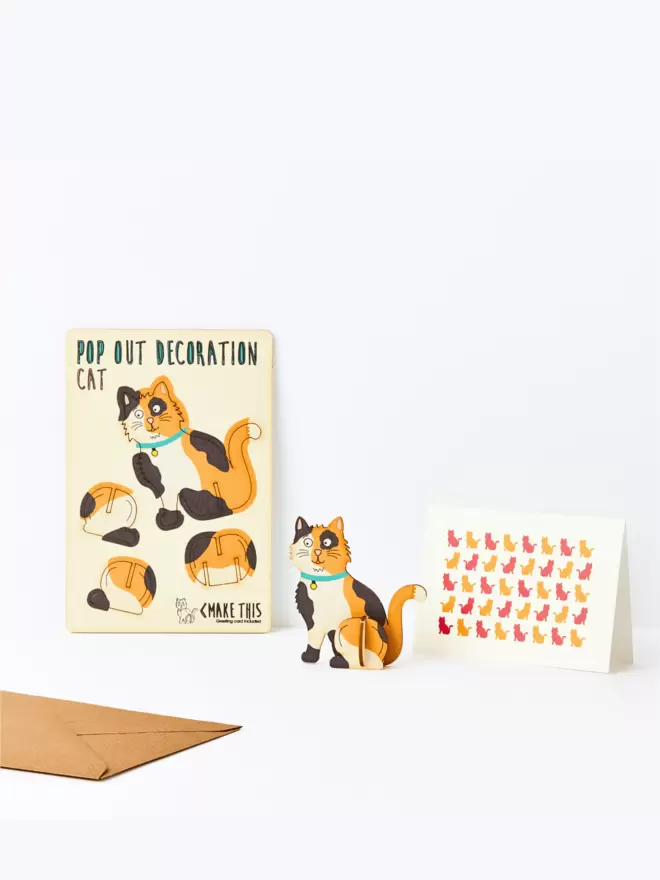 Calico tabby cat decoration and cat pattern greeting card and brown kraft envelope on a white background