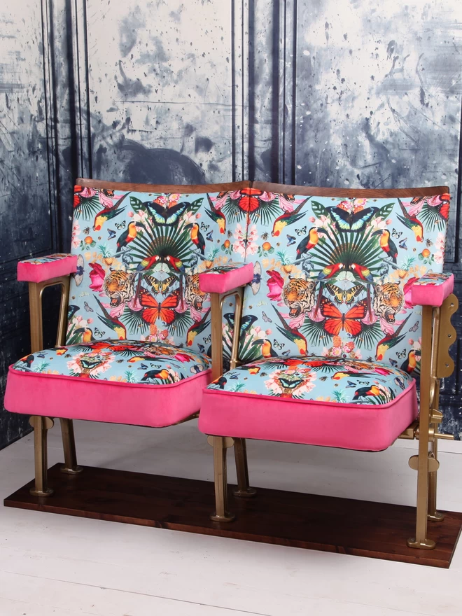 A set of two vintage cinema seats fully refurbished and upholstered in blue velvet with pink velvet panelling and piping