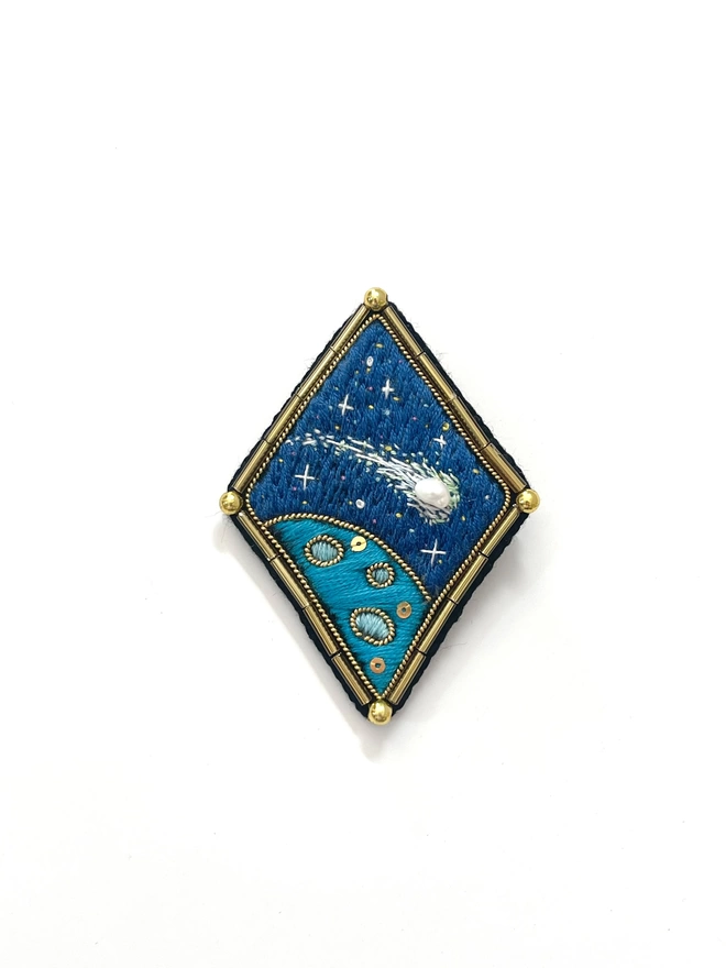 Shooting star brooch on white background