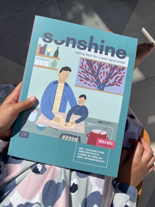 Sonshine magazine issue 21 a green mag with an illustration of father and son baking on the cover on person's lap