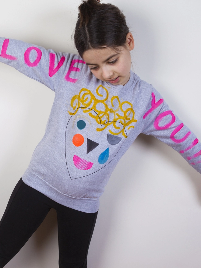 Young girl wearing her designed heart sweat