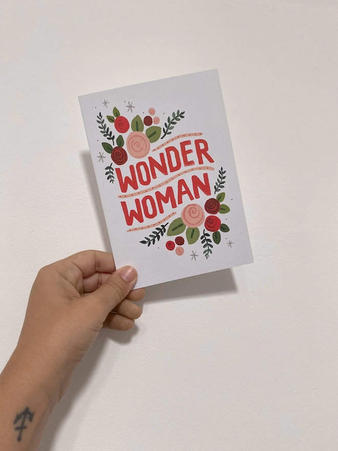 wonder woman card in hand