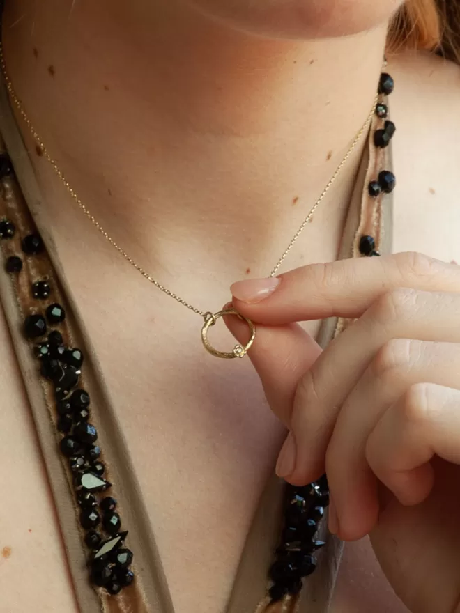 Karma Circle Diamond Necklace seen on a woman