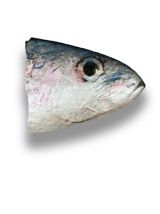 painting of a sardine fish face onto a repurposed surfboard