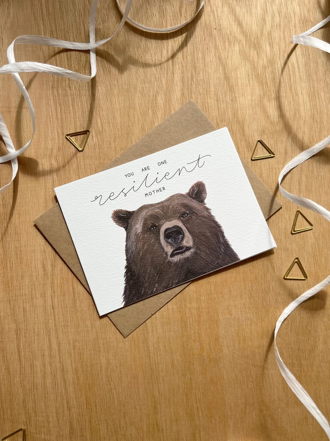 a greetings card featuring the face of a brown bear with the phrase “you are one resilient mother”