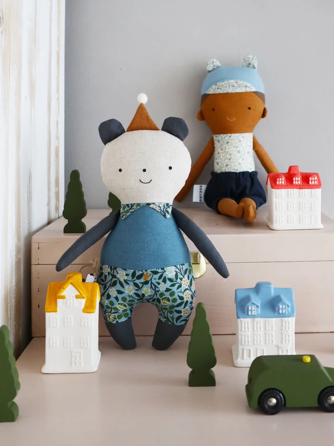stuffed panda bear doll in blue outfit and william morris print