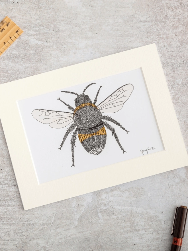 Note card with intricately patterned pen and watercolour drawing of a bee, in a soft white mount