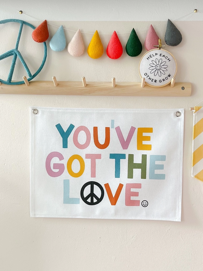You’ve got the love wall banner hanging on. A cream background wall