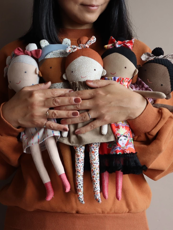 diverse collection of fabric dolls