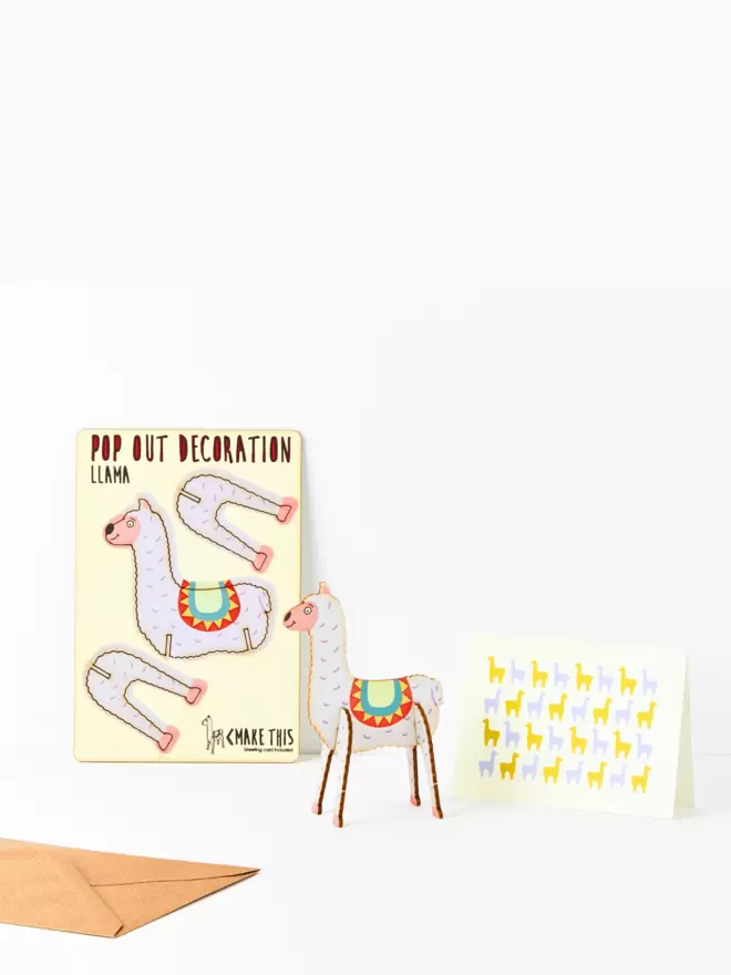 Llama decoration and llama pattern greeting card and brown kraft envelope on a white background