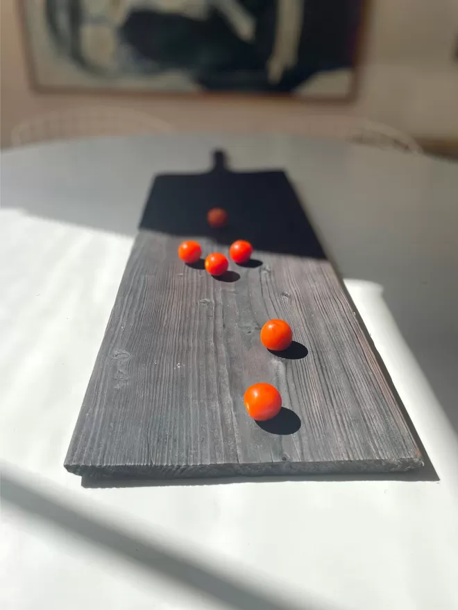 Long Charred Black Serving Board With Tomatoes