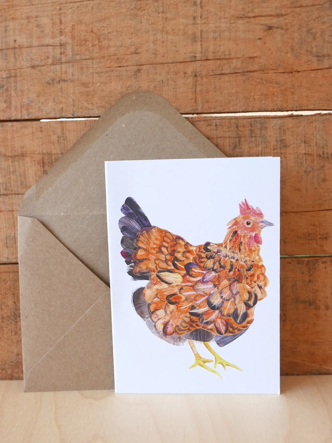 The Mother Hen Card next to its brown envelope with the front of the card visible