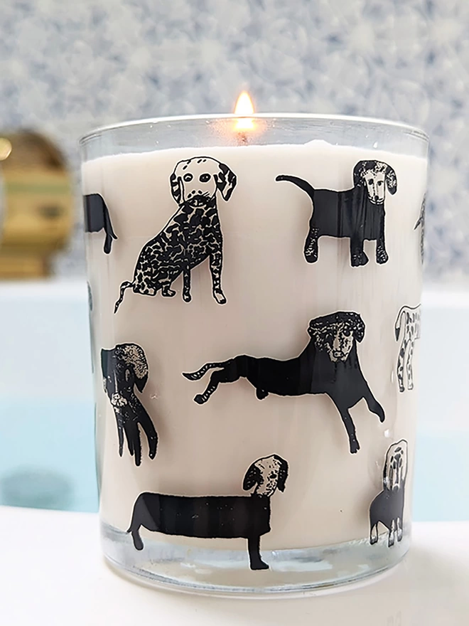 dogalicious rhubarb & ginger candle in a Reusable glass with black dog illustrations in bathroom setting