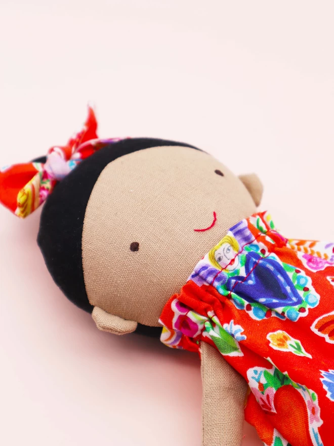 mexican doll with black hair and red colourful dress