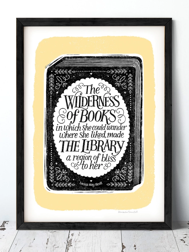 black and yellow hand lettered reading quote print in black frame