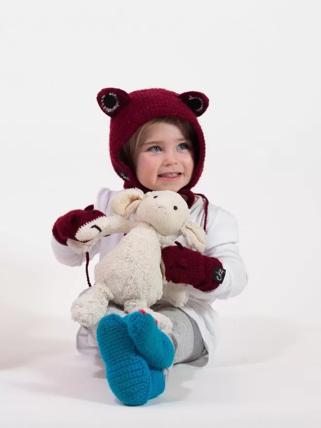 EKA Animal Bonnet seen on a child with a teddy.