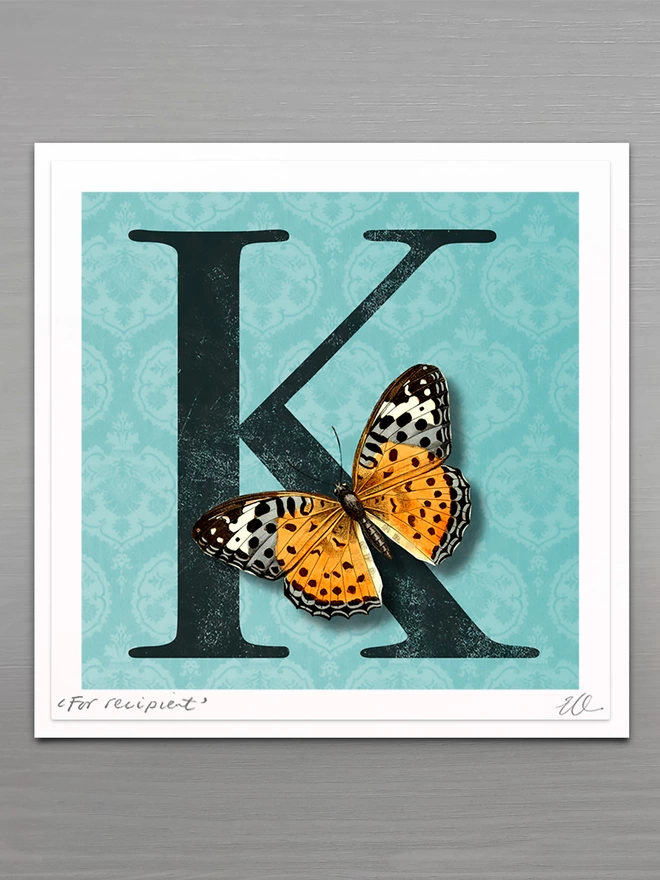 personalised birthday card with large letter on a blue coloured patterned background with a 3D paper cut butterfly
